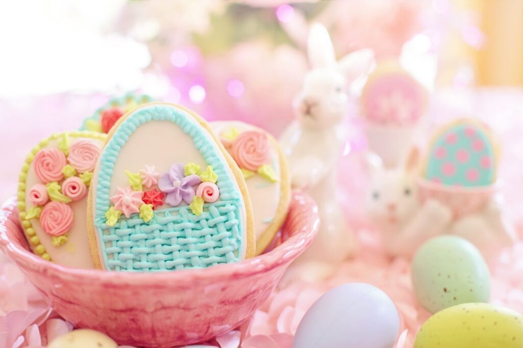 A delightful Easter-themed image featuring decorated cookies in a basket with bunnies and pastel eggs.