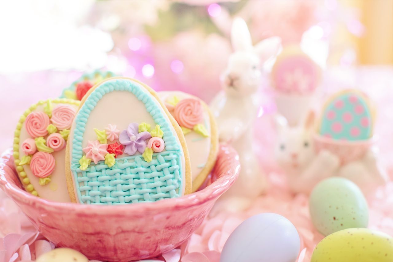 A delightful Easter-themed image featuring decorated cookies in a basket with bunnies and pastel eggs.